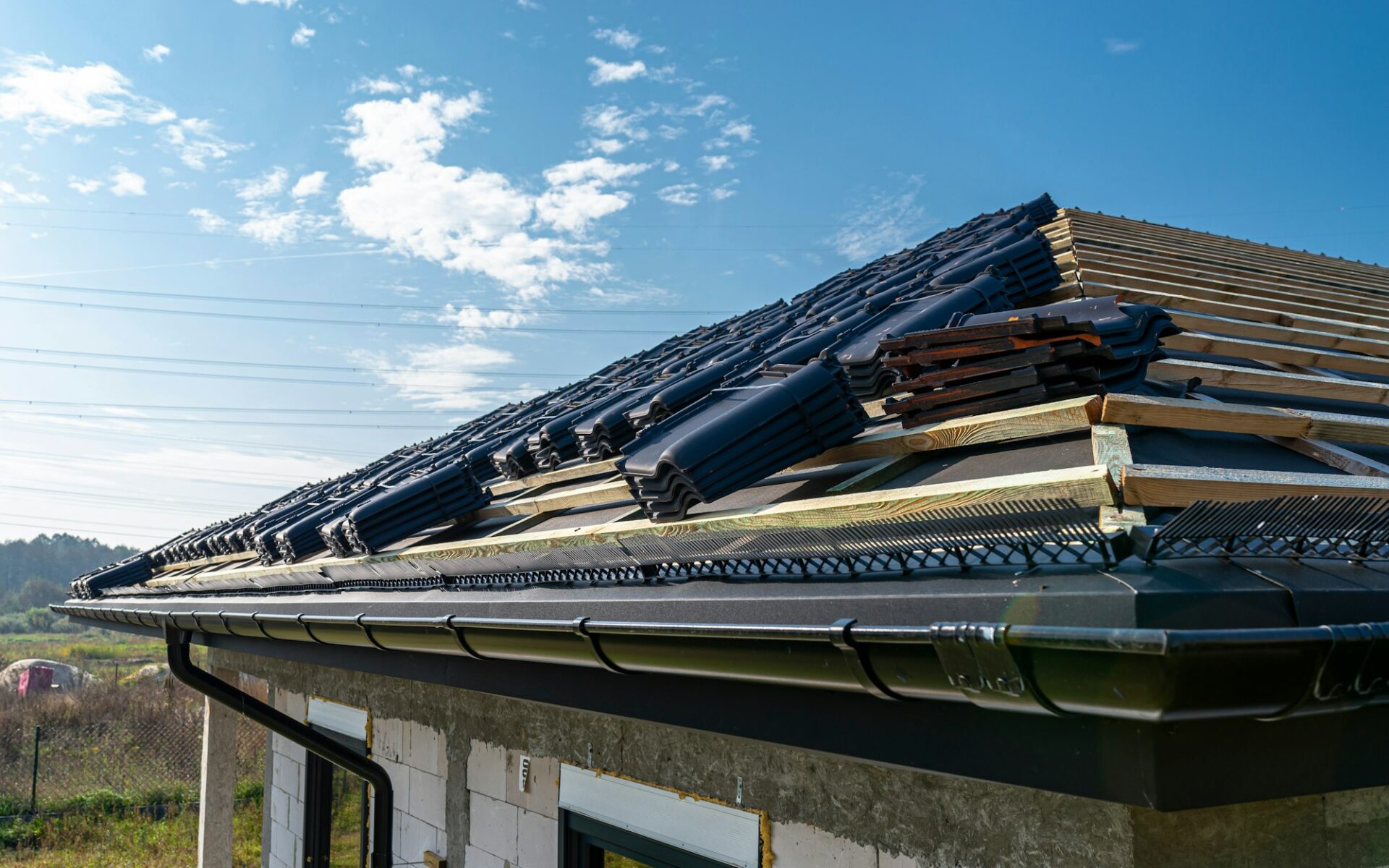 Roof ceramic tile arranged in packets on the roof on roof battens. Preparation for laying roof tiles